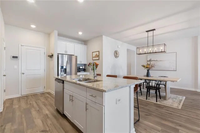 a kitchen with a sink a counter space and wooden floor