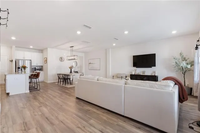 a living room with furniture and a view of kitchen