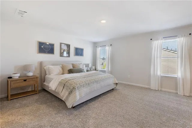 a bedroom with a bed and a night stand