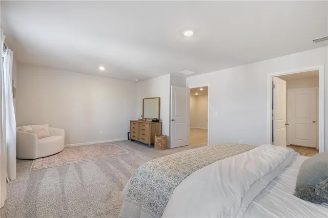 a view of walk in closet with clothes