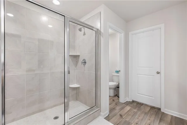 a bedroom with a large bed and a view of bathroom