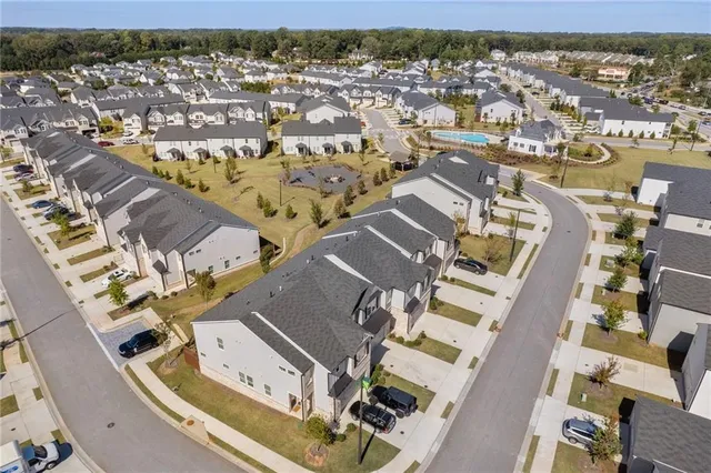 an aerial view of a house with a yard