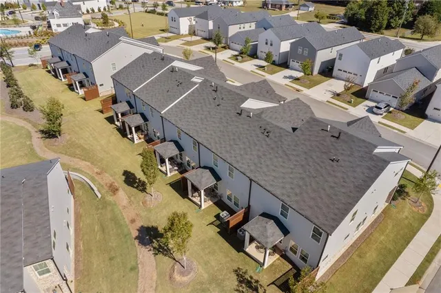 an aerial view of a house with garden space and street view