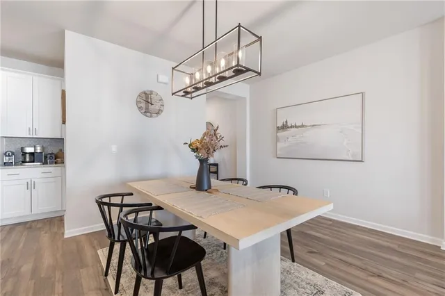 a view of a dining room with furniture wooden floor and chandelier