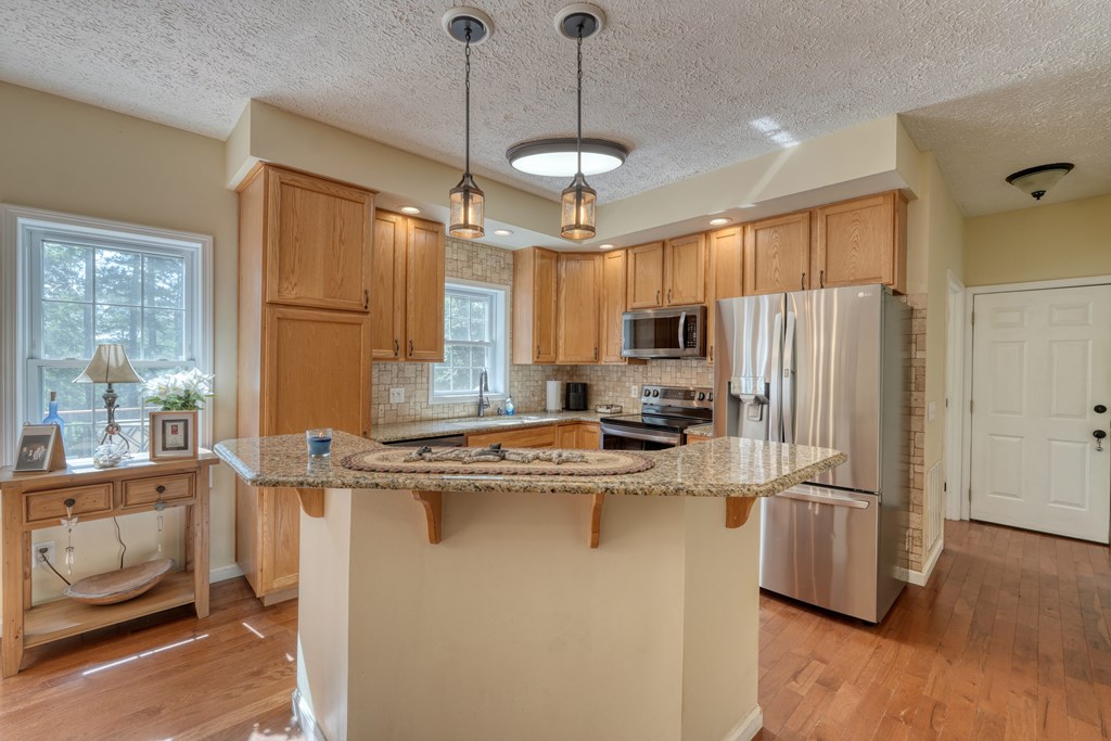 79 Mashie Lane Murphy, NC 28906 - Photo 25 of 76 a kitchen with kitchen island a counter top space appliances and a window