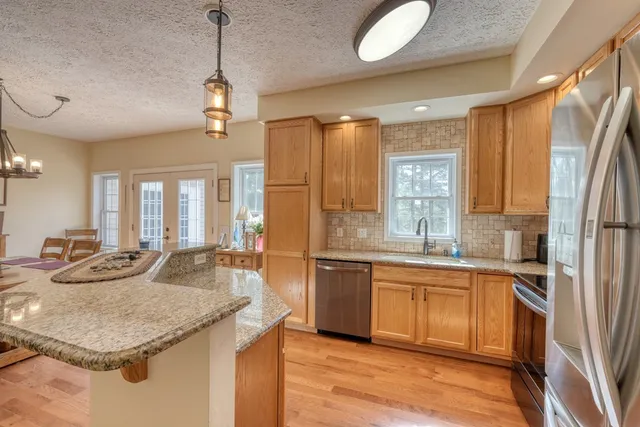 a bedroom with a bed and a lamp on dresser