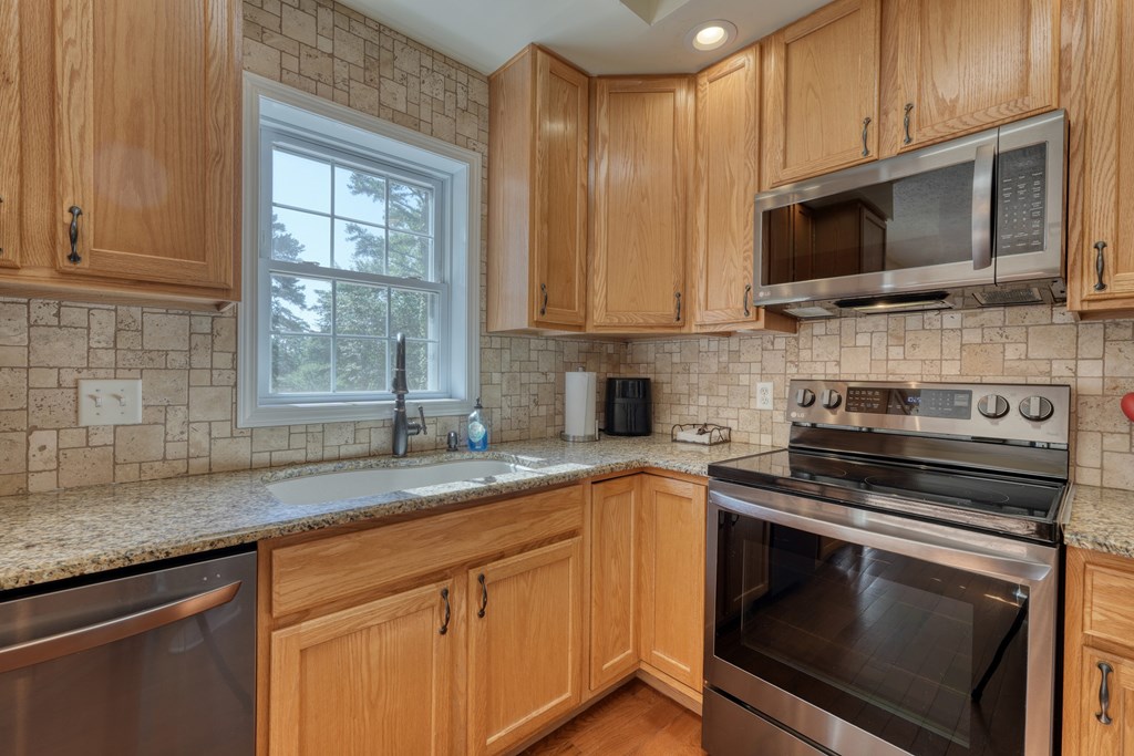 79 Mashie Lane Murphy, NC 28906 - Photo 28 of 76 a kitchen with stainless steel appliances granite countertop a sink stove and microwave