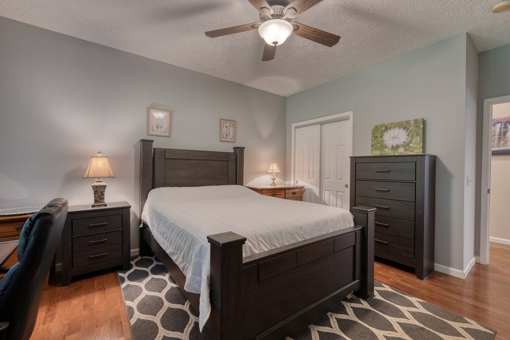 79 Mashie Lane Murphy, NC 28906 - Photo 39 of 76 a bedroom with a bed and a lamp on dresser