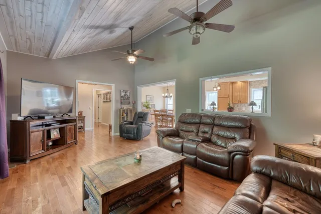 an aerial view of a house with a yard and large trees