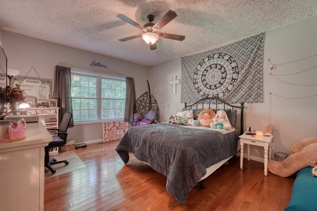 79 Mashie Lane Murphy, NC 28906 - Photo 41 of 76 a bedroom with a bed and a large window with wooden floor