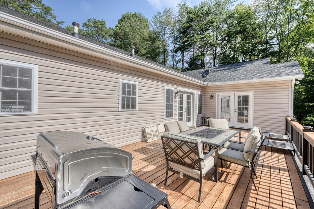 79 Mashie Lane Murphy, NC 28906 - Photo 64 of 76 a view of a patio with table and chairs with wooden floor and fence