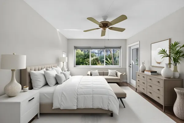 a large bedroom with a bed and a chandelier