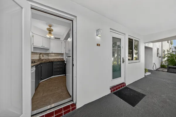 an empty room that has a glass door and painted walls