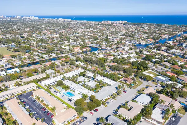 a car parked in front of a building with small garden