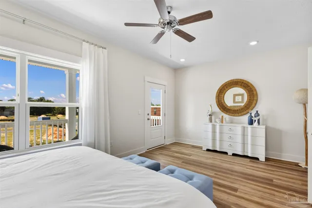 a bedroom with bed and wooden floor