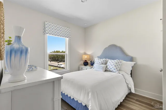 a bedroom with a bed and a potted plant