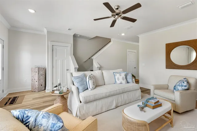 a living room with a bed furniture and a potted plant