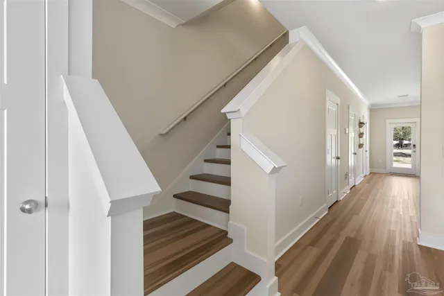 a view of entryway and hall with wooden floor