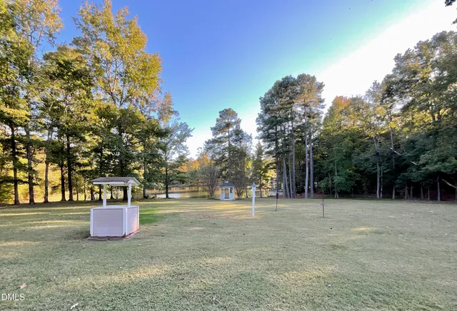 a house view with swimming pool next to a yard