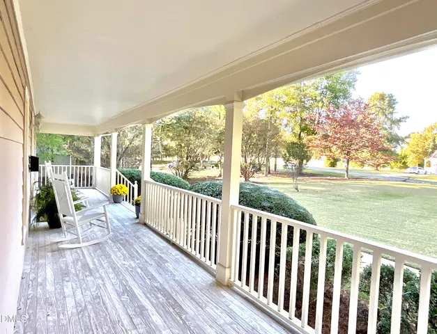 a view of balcony with couch and chairs