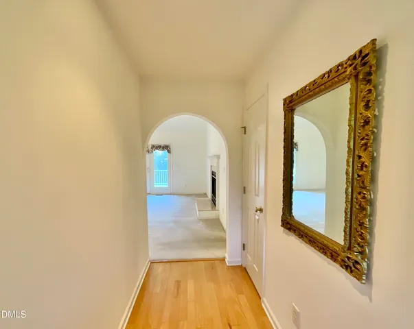 a view of a hallway with wooden floor and entryway