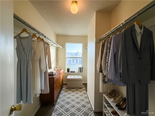 a walk in closet with a couch