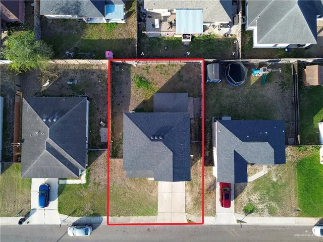an aerial view of residential houses with outdoor space