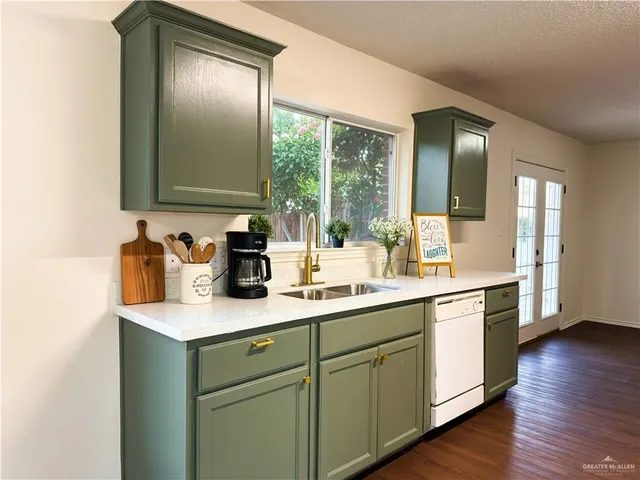 a kitchen with sink and cabinets