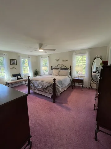a spacious bedroom with a bed and window