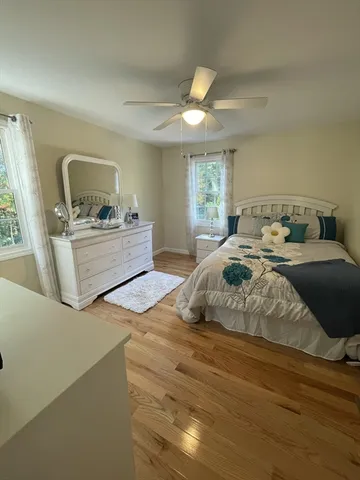 a bedroom with a bed and a large window
