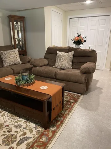 a living room with furniture and a bed