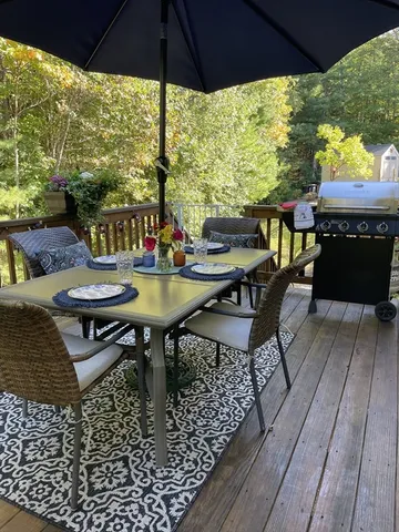 a view of a outdoor sitting area with furniture and umbrella