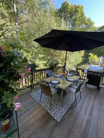an outdoor sitting area with furniture and wooden floor