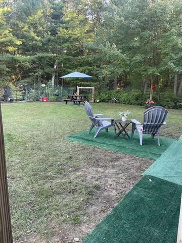 a view of outdoor space with playground and green space