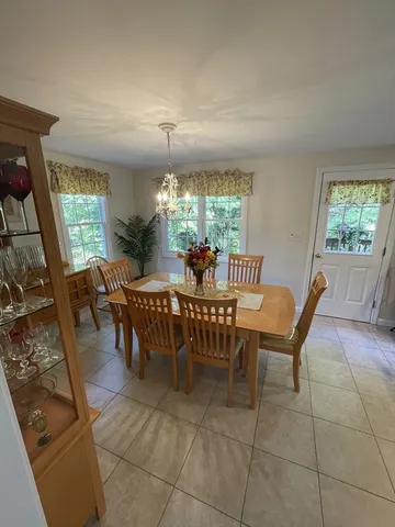 a view of a dining room with furniture window and outside view