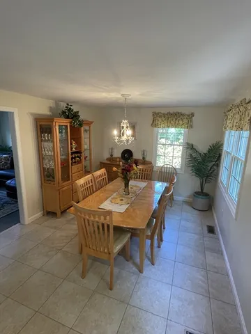 a dining room with furniture and window