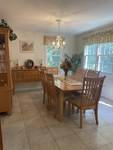 a view of a dining room with furniture and chandelier