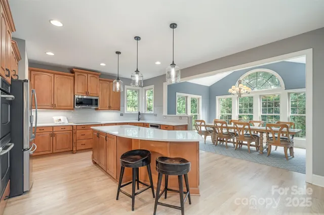 a large kitchen with lots of counter space dining table and chairs