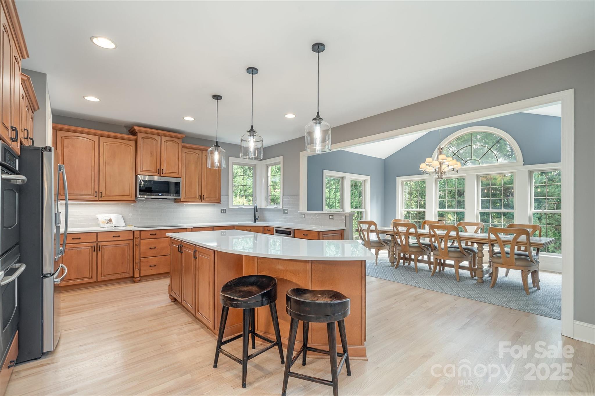 9021 Unbridle Lane Waxhaw, NC 28173 - Photo 13 of 48 a large kitchen with lots of counter space dining table and chairs