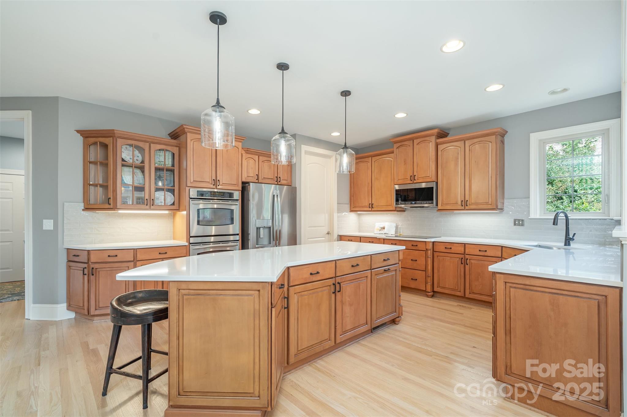 9021 Unbridle Lane Waxhaw, NC 28173 - Photo 15 of 48 a open kitchen with stainless steel appliances granite countertop a sink stove and refrigerator