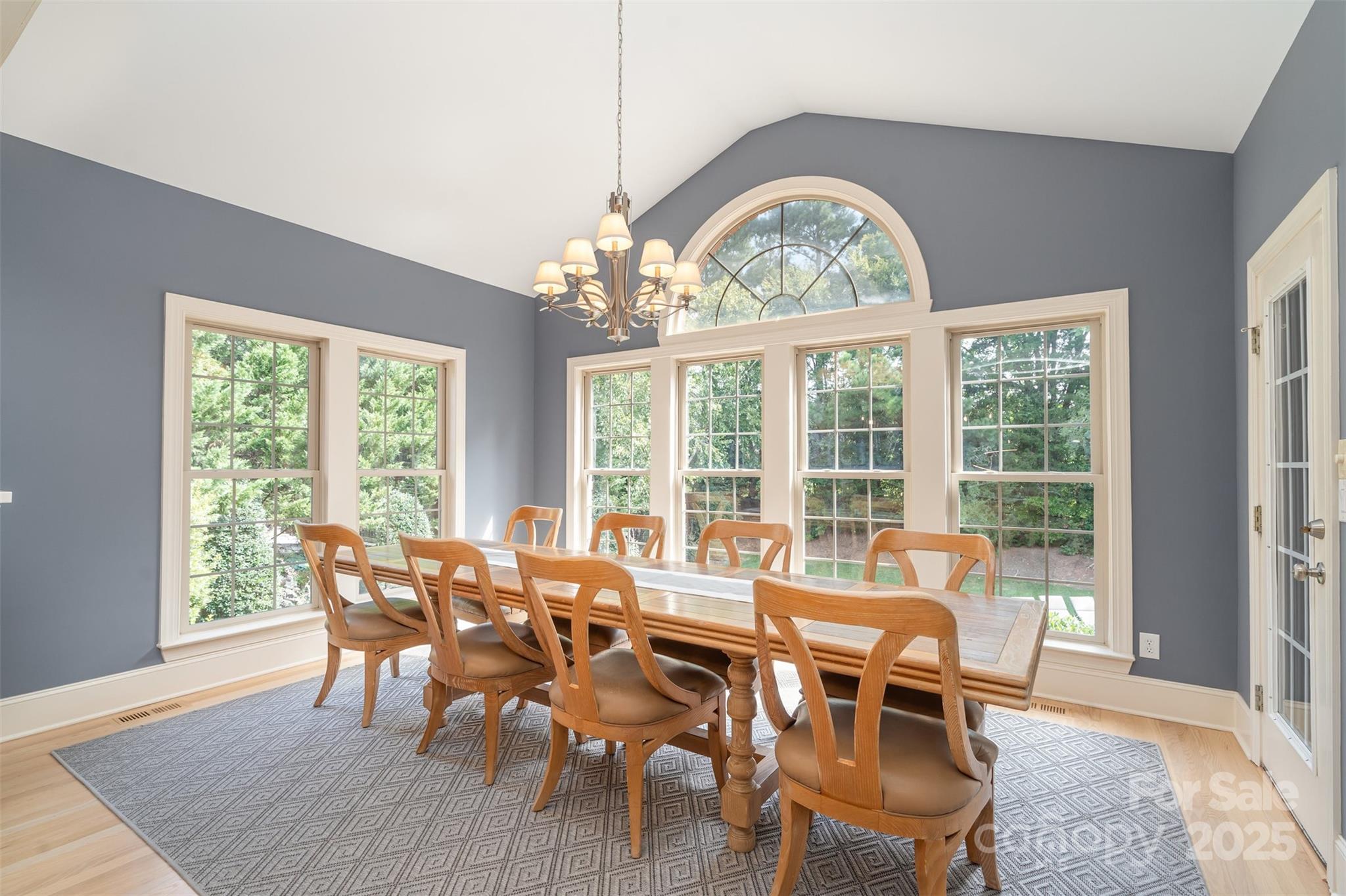 9021 Unbridle Lane Waxhaw, NC 28173 - Photo 17 of 48 a view of a dining room with furniture large windows and wooden floor