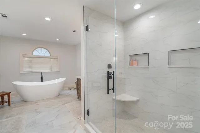 a spacious bathroom with a bathtub and toilet