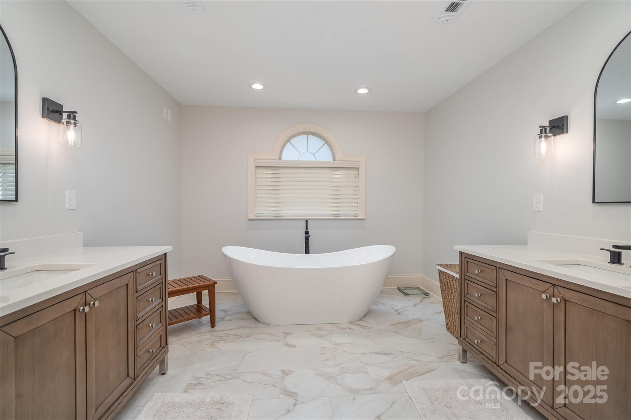 9021 Unbridle Lane Waxhaw, NC 28173 - Photo 24 of 48 a spacious bathroom with a sink and a bathtub