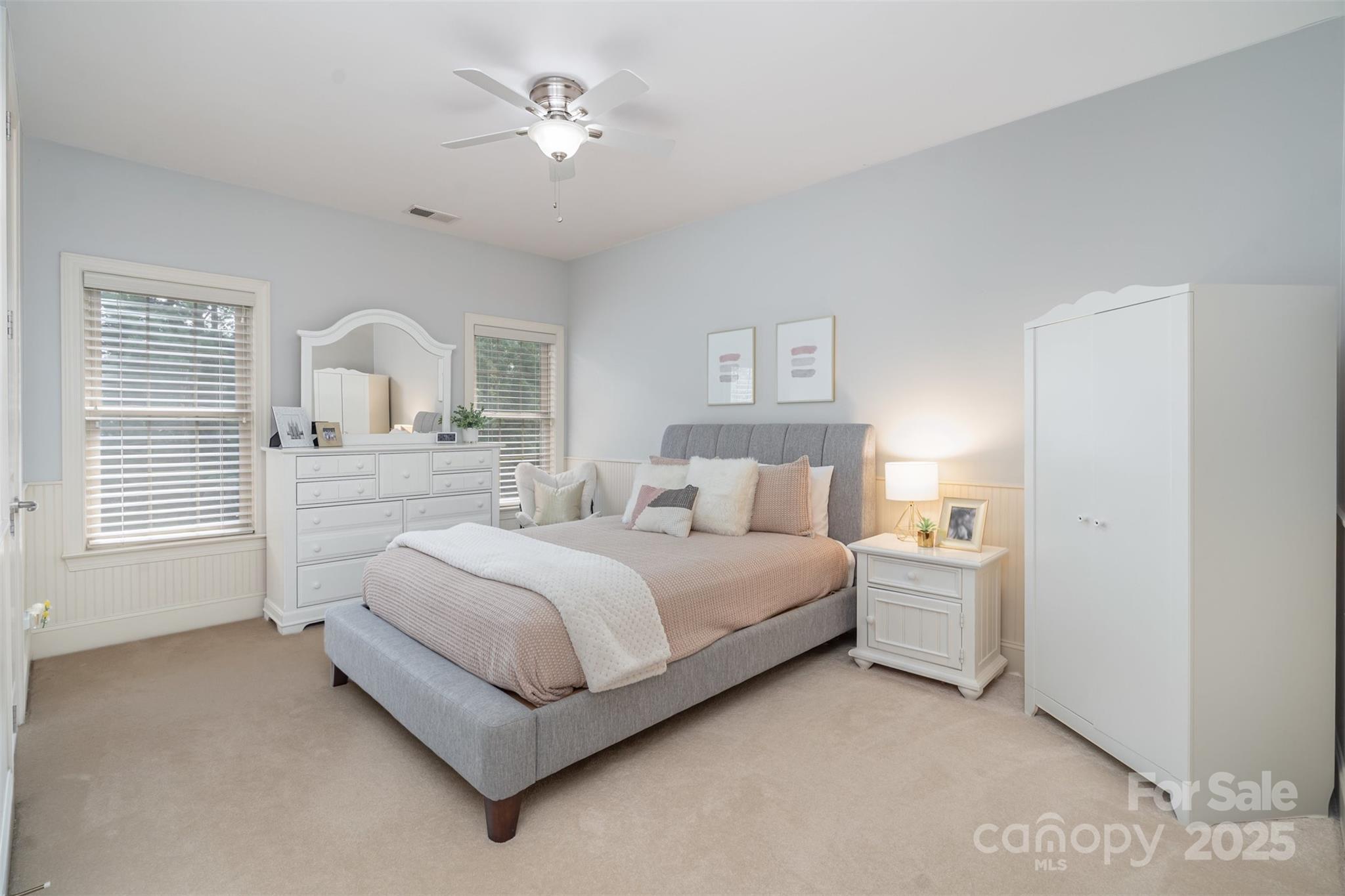 9021 Unbridle Lane Waxhaw, NC 28173 - Photo 30 of 48 a spacious bedroom with a bed and a chandelier