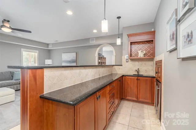 a kitchen with stainless steel appliances granite countertop a sink and a microwave