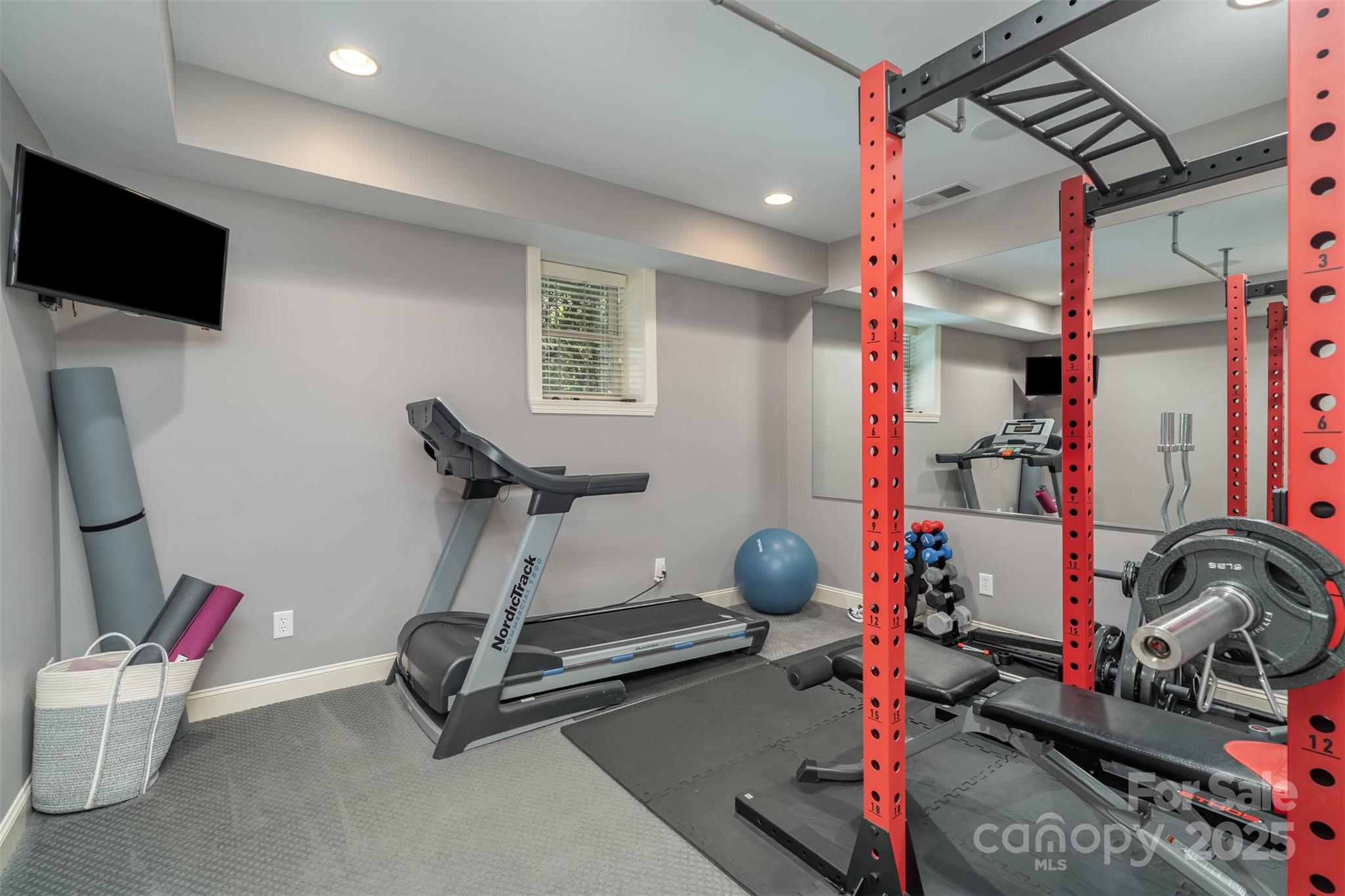 9021 Unbridle Lane Waxhaw, NC 28173 - Photo 40 of 48 a room with gym equipment and a flat screen tv