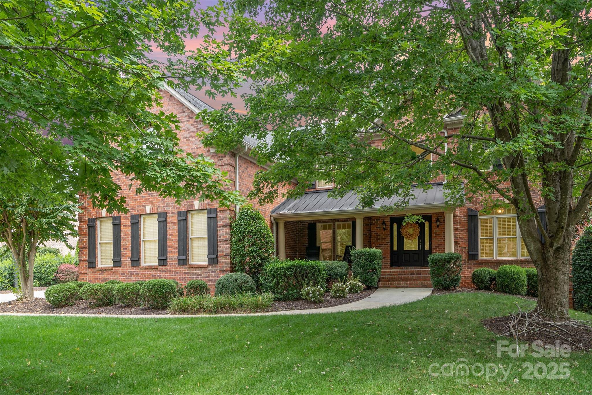 9021 Unbridle Lane Waxhaw, NC 28173 - Photo 4 of 48 a front view of a house with a yard and porch