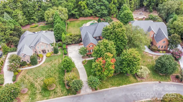 an aerial view of a house with garden space and street view