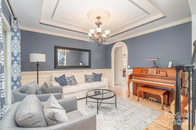a living room with furniture and a chandelier