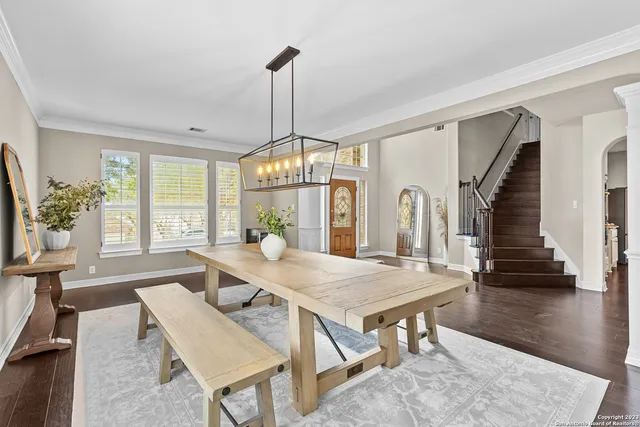 a view of a dining room with furniture window and wooden floor